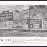 Promotional postcard by Pioneer Advertising Featuring a billboard with a photo of Duke Kahnamoku surfing by A.R. Gurrey