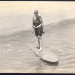 Real Photo Unknown woman riding Duke's surfboard (horizontal)